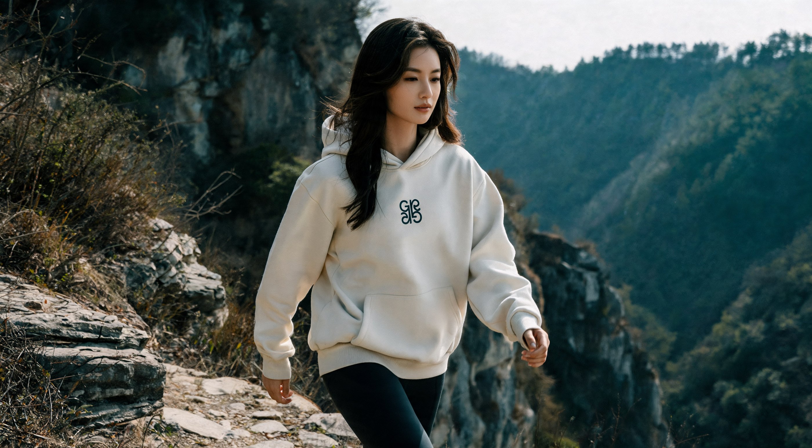 The Baton Hoodie, Off White, on a mountain trail